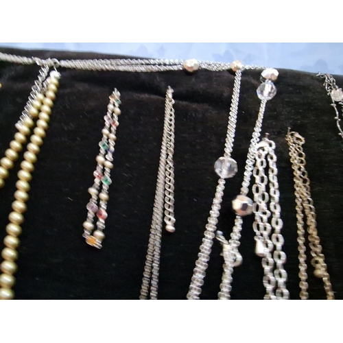 10 - Collection of 15 x Assorted Necklaces and a Bracelet on Free-Standing Black Velvet Padded Display