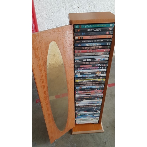 229 - Teak Coloured DVD Stand with 42 x Assorted Movies on DVD's (Stand 23 x 17 x 85cm)