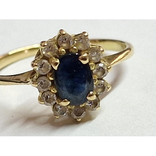 132 - 18ct Gold Ring with Sapphire(?) and Surrounding Clear Stones, (Approx. 2.1g, Size: K)