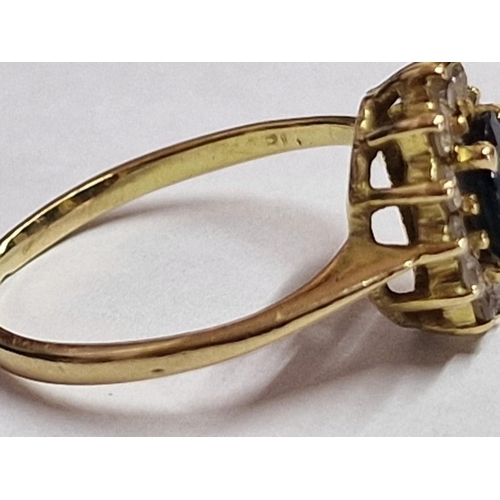 132 - 18ct Gold Ring with Sapphire(?) and Surrounding Clear Stones, (Approx. 2.1g, Size: K)