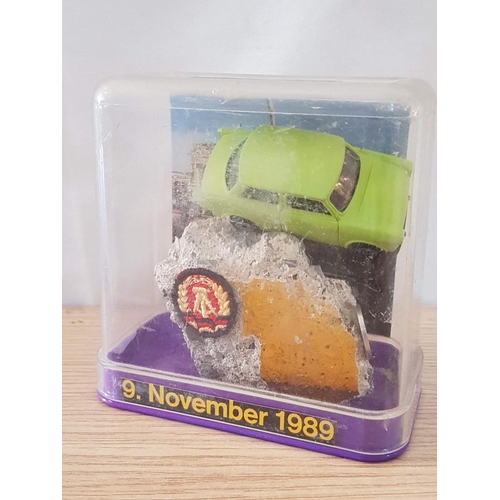 30A - Berlin Souvenir / Memento of 9 November 1989; Piece of the Berlin Wall with Model Car, Coin, Coat of... 