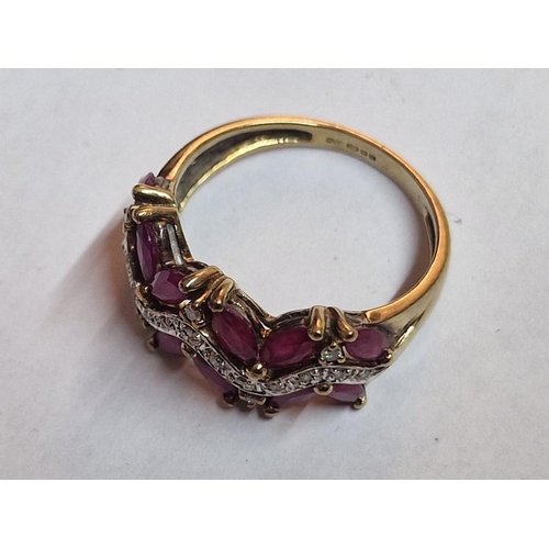 168 - 9ct Gold Ruby and Diamond Ring; Attractive Angled Arrangement of 12 x Oval Cut Rubies with Qty of Di... 