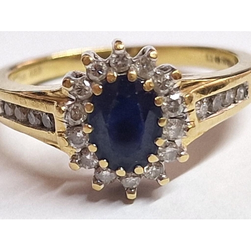 103 - 18ct Gold, Sapphire and Diamond Ring; Central Oval Cut Sapphire, (Approx. 7 x 5mm) with Surrounding ... 