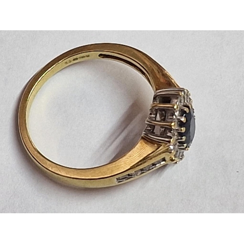 103 - 18ct Gold, Sapphire and Diamond Ring; Central Oval Cut Sapphire, (Approx. 7 x 5mm) with Surrounding ... 