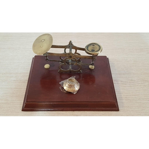 24 - Vintage brass postal scales on wooden plinth with interlocking brass weights