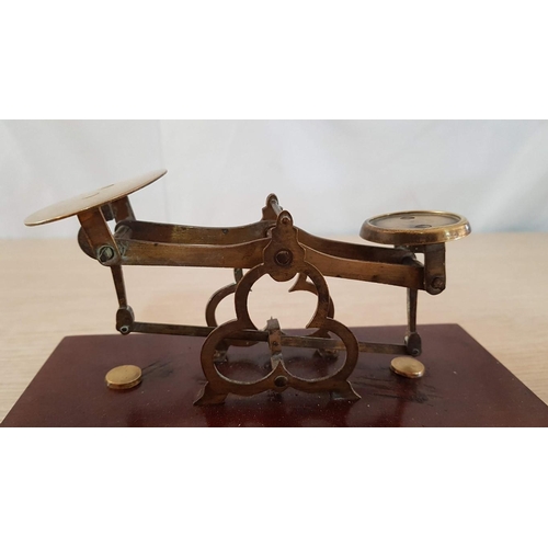 24 - Vintage brass postal scales on wooden plinth with interlocking brass weights