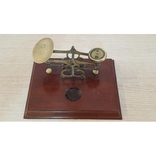 24 - Vintage brass postal scales on wooden plinth with interlocking brass weights