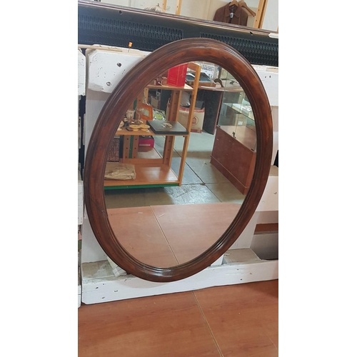 68 - Large oval mirror in an Edwardian oak frame – 77cm x 57