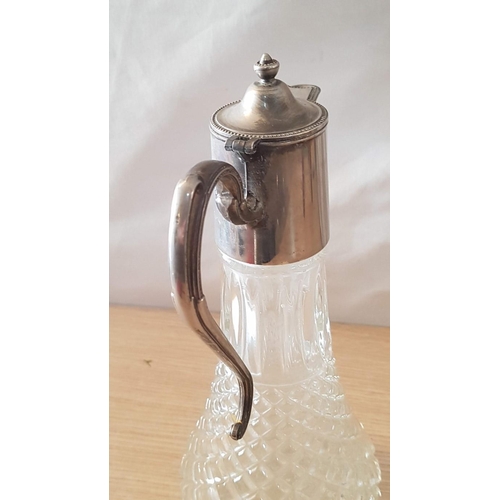 72 - English made glass claret jug with metal handle and spout – 29cm high