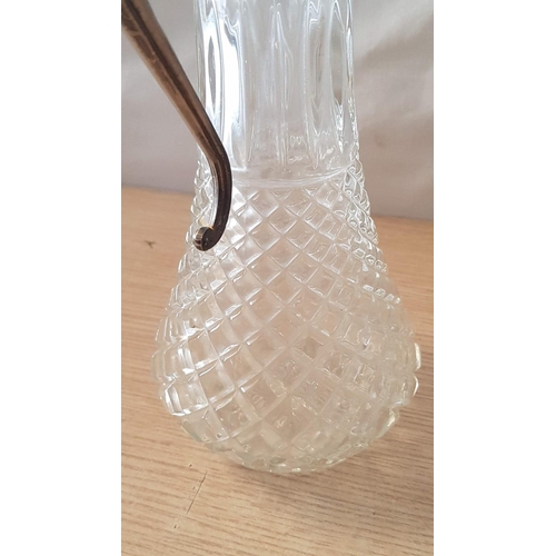 72 - English made glass claret jug with metal handle and spout – 29cm high