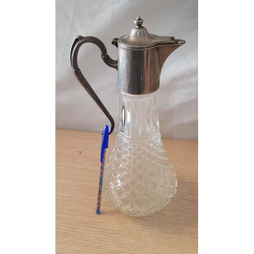 72 - English made glass claret jug with metal handle and spout – 29cm high