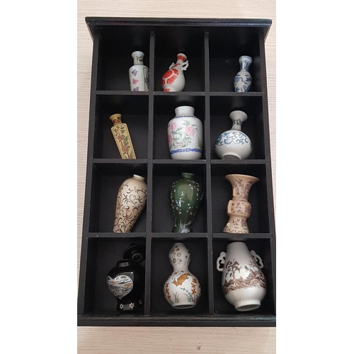 3 - Wall hung black wooden display cabinet containing 12 miniature vases – ‘Treasures of the Imperial Dy... 