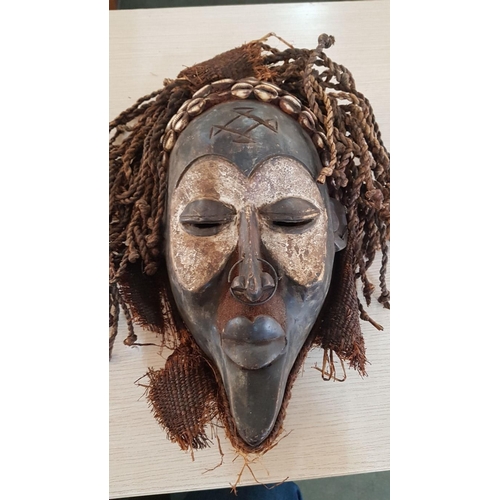 74 - A primitive large African, Chukwe Helm mask – 40cm x 26 and a fantasy/mythological wall hanging made... 