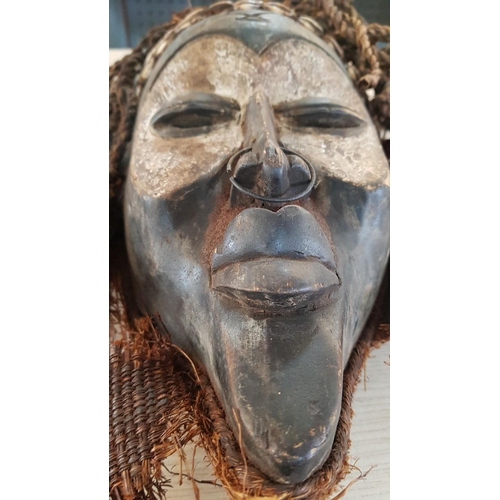 74 - A primitive large African, Chukwe Helm mask – 40cm x 26 and a fantasy/mythological wall hanging made... 