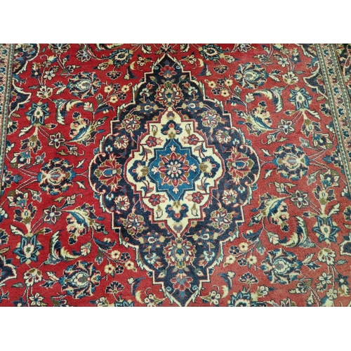 321 - Large Persian Style Carpet in Traditional Pattern with Centre Medallion and Decorative Border in Red... 