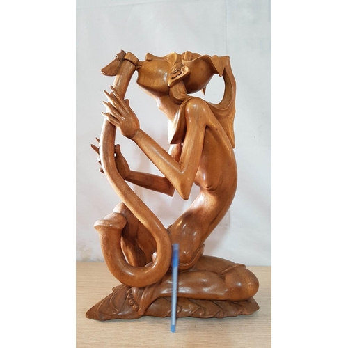 215 - Balinese Art Deco Wooden Sculpture, A Flutist, (Approx. H: 50cm)