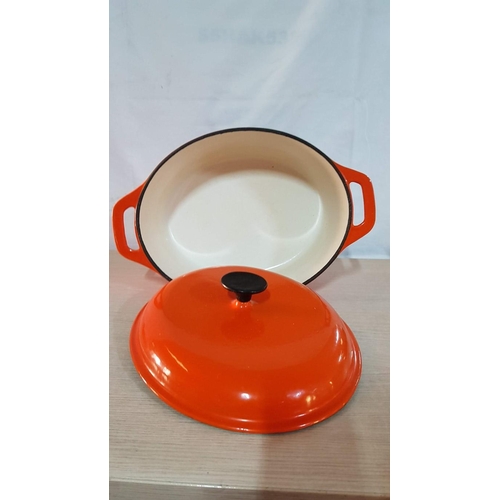 25D - 'Vogue' Large Cast Iron Oval Lidded Casserole Dish, Enameled, Off White Interior and Orange Exterior... 