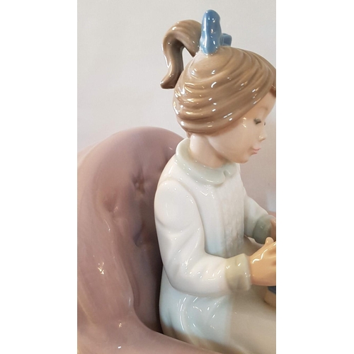 134 - Nao by Lladro 'Birthday Girl' (Girl Carrying Gift and Setting on Armchair), Porcelain Figurine, Made... 