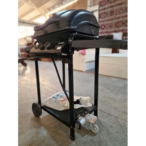 222 - Omega Gas Barbeque (BBQ) on Fitted Stand with Wheels, Together with Part Bag of Charcoal and Cleanin... 