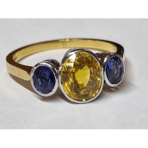 100 - 18ct Gold and Sapphire Ring; Central Oval Cut 1.75ct Yellow Sapphire, with Pair of Adjoining Oval Cu... 