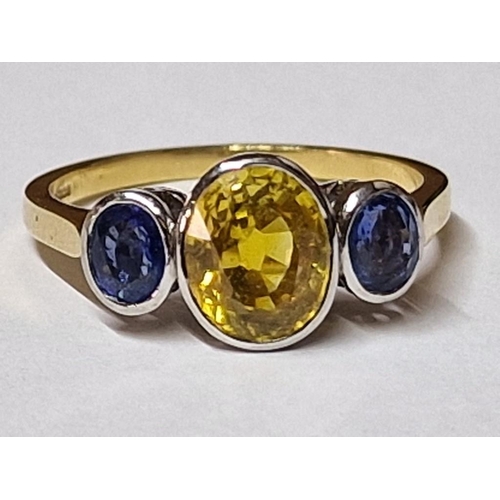 100 - 18ct Gold and Sapphire Ring; Central Oval Cut 1.75ct Yellow Sapphire, with Pair of Adjoining Oval Cu... 