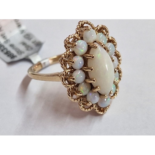 101 - 9ct & Opal Ring; Marquise Cluster of Opals (Large Oval Shape Centre with 12 x Surrounding), in Ornat... 