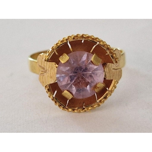 158 - 18ct Gold Ring with Large Light Purple Tone Round Stone in Raised Surround with Leaf Design Shoulder... 