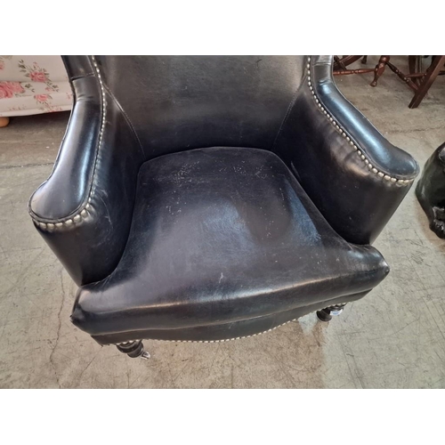 7 - Black Leather Effect Wingback Armchair with Studded Surround Over Turned Front Legs with Casters