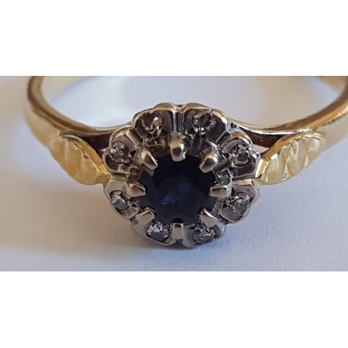 136 - 'Daisy' 18ct Gold Ring, Single Sapphire Stone (?)Surrounded by 8- Diamonds, Approx. 3.7g Size