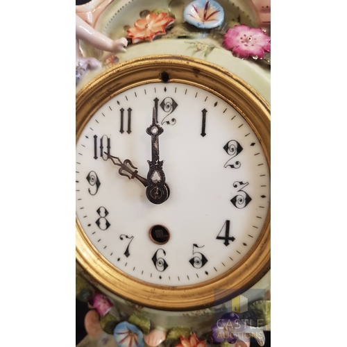 1 - A Decorative Continental Porcelain Mantel Clock, Richly Modelled with Applied Flowers, Scrollwork an... 