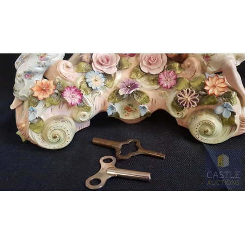 1 - A Decorative Continental Porcelain Mantel Clock, Richly Modelled with Applied Flowers, Scrollwork an... 