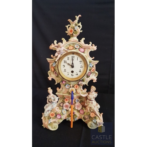 1 - A Decorative Continental Porcelain Mantel Clock, Richly Modelled with Applied Flowers, Scrollwork an... 