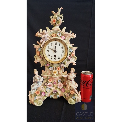 1 - A Decorative Continental Porcelain Mantel Clock, Richly Modelled with Applied Flowers, Scrollwork an... 