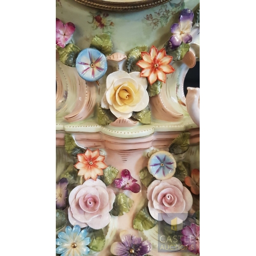 1 - A Decorative Continental Porcelain Mantel Clock, Richly Modelled with Applied Flowers, Scrollwork an... 