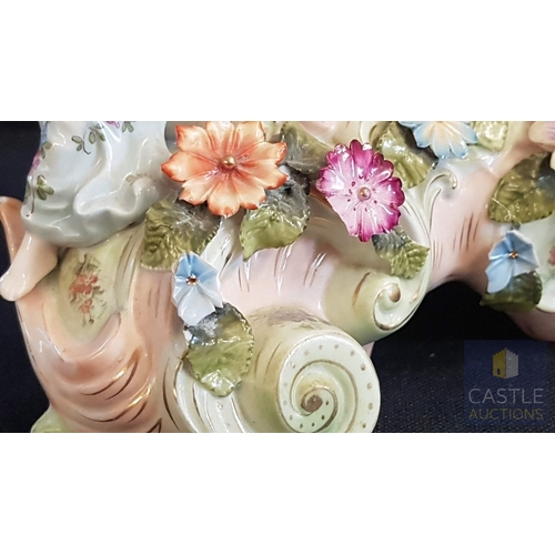 1 - A Decorative Continental Porcelain Mantel Clock, Richly Modelled with Applied Flowers, Scrollwork an... 