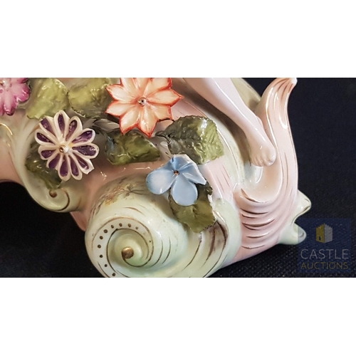 1 - A Decorative Continental Porcelain Mantel Clock, Richly Modelled with Applied Flowers, Scrollwork an... 