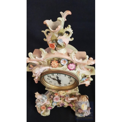 1 - A Decorative Continental Porcelain Mantel Clock, Richly Modelled with Applied Flowers, Scrollwork an... 