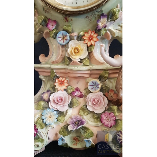 1 - A Decorative Continental Porcelain Mantel Clock, Richly Modelled with Applied Flowers, Scrollwork an... 
