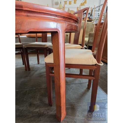 A Chinese-Style Round Wooden Dining Table with Ten Matching Chairs and ...