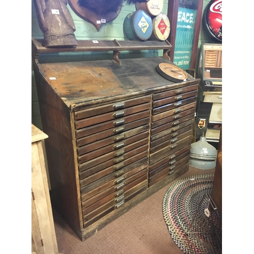 521 - Early 1900's thirty wooden printer's drawers with brass handles. (127 cm L x 46 cm D x 135 cm H)