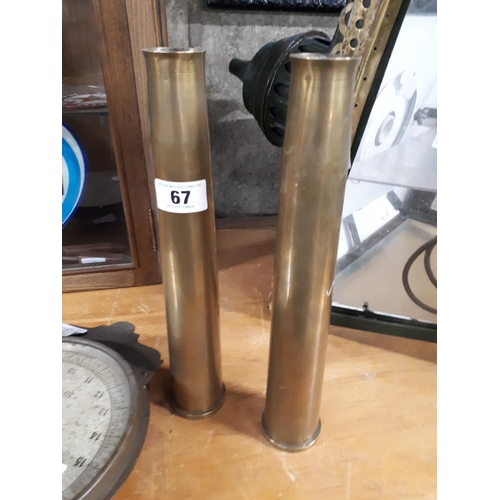 67 - Two brass gun shells.