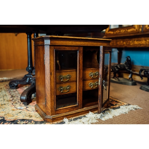 101 - Early 20th C. smokers cabinet with two glazed doors and fitted interior.