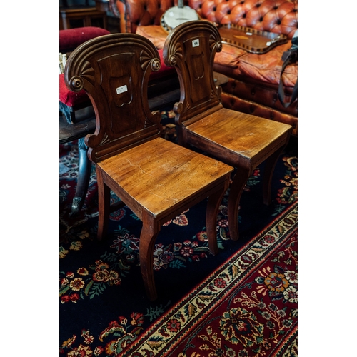 109 - Pair of Regency mahogany hall chairs.