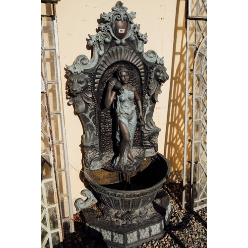 667 - Decorative bronze wall fountain the back decorated with lion's masks and a maiden standing on a plin... 