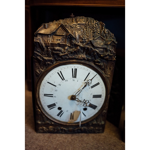 73 - 19th C. embossed brass wall clock with enamel dial and Roman numerals.