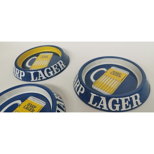 60 - Set of three Harp Lager tin advertising trays. { 20cm Dia. }.