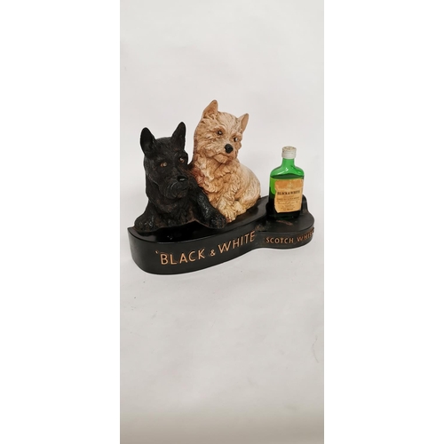 64 - Black & White Whisky Scottie Dogs rubberoid advertisement. {24cm H X 31cm W X 10cm D }.