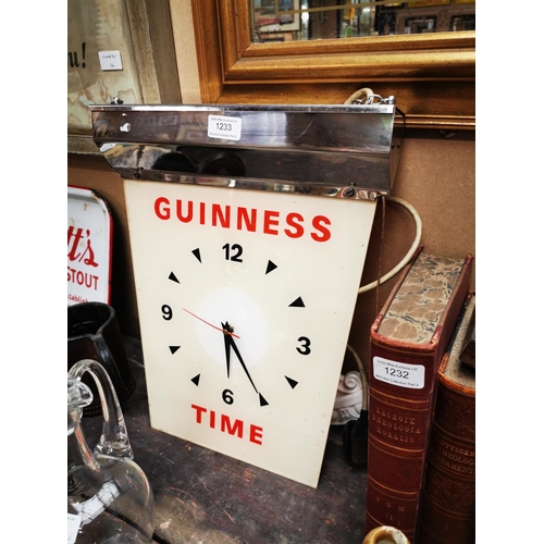 1233 - Guinness Time hanging advertising clock {43 cm H x 34 cm W}.