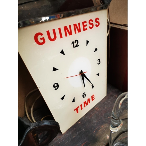 1233 - Guinness Time hanging advertising clock {43 cm H x 34 cm W}.