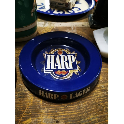 171 - Two Harp Lager ashtrays  - one ceramic  & one plastic.